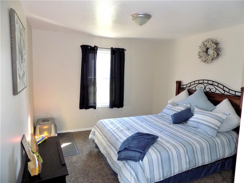 175 Springer Road McClellandtown, PA 15458 - Photo 11 of 18 a bedroom with a bed and wooden floor