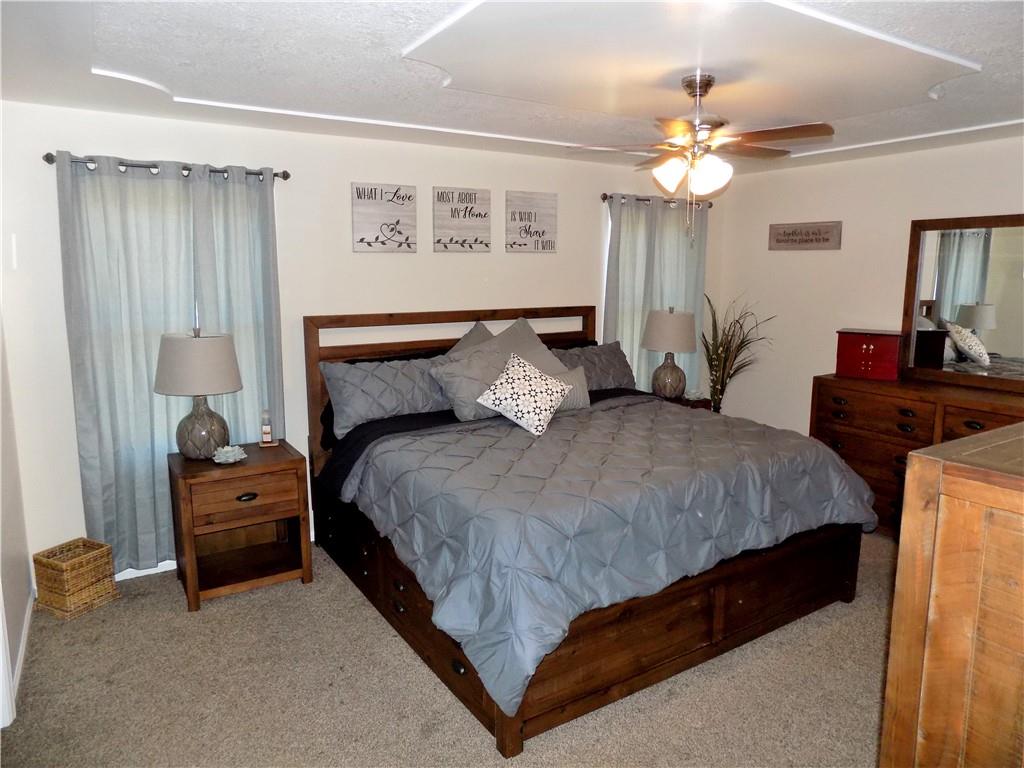 175 Springer Road McClellandtown, PA 15458 - Photo 6 of 18 a bedroom with a bed and a chandelier