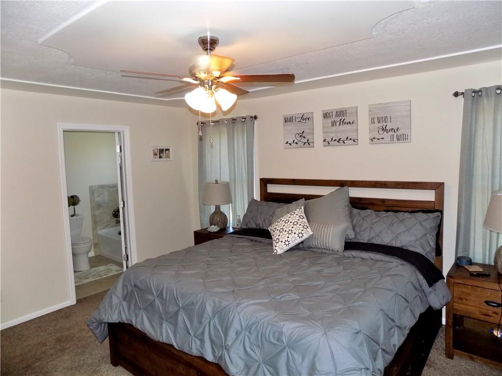 175 Springer Road McClellandtown, PA 15458 - Photo 7 of 18 a bedroom with a bed and a chandelier