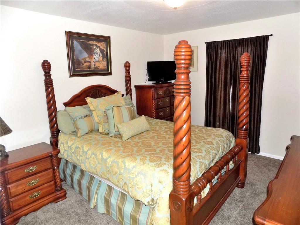 175 Springer Road McClellandtown, PA 15458 - Photo 9 of 18 a bedroom with bed and a flat tv screen