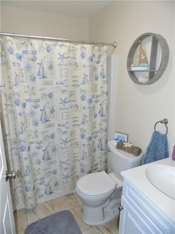175 Springer Road McClellandtown, PA 15458 - Photo 10 of 18 a white toilet sitting next to a shower curtain