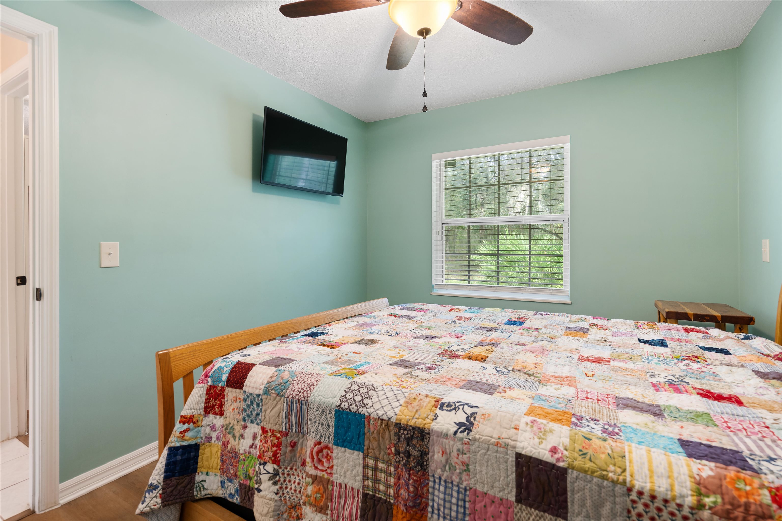 5525 St Ambrose Church Road Elkton, FL 32033 - Photo 24 of 66 a bedroom with a bed and a flat screen tv