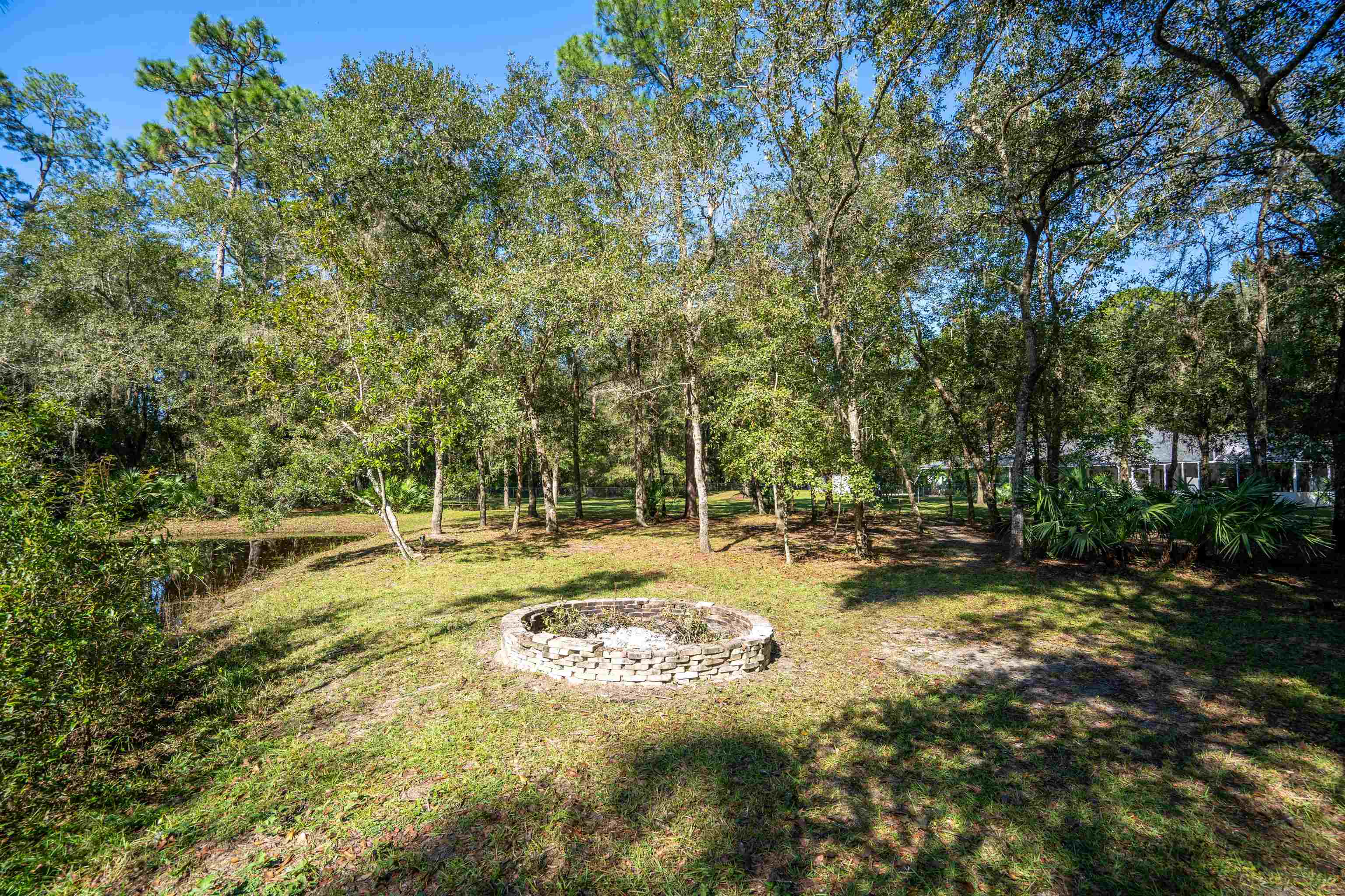 5525 St Ambrose Church Road Elkton, FL 32033 - Photo 39 of 66 a view of a fire pit with large trees