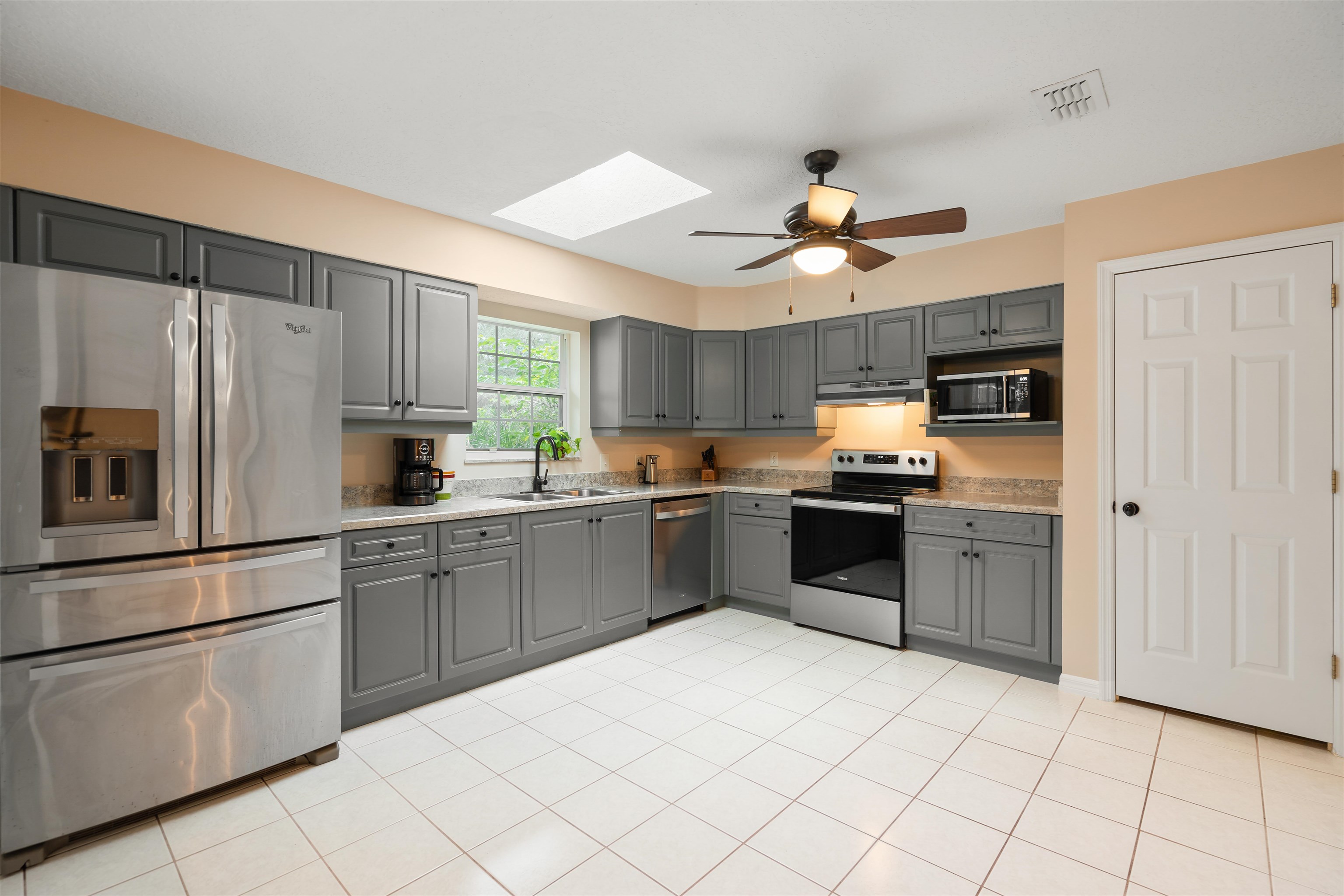 5525 St Ambrose Church Road Elkton, FL 32033 - Photo 9 of 66 a kitchen with granite countertop stainless steel appliances and white cabinets