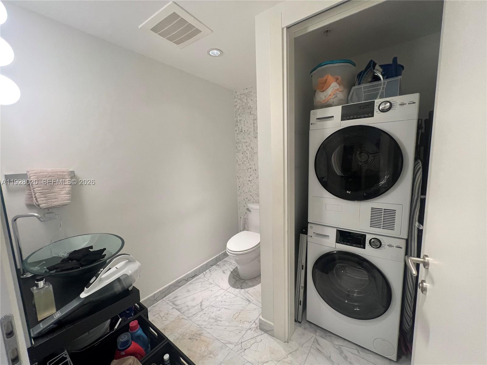 200 Biscayne Blvd Way, Unit 3106 Miami, FL 33131 - Photo 20 of 27 a view of a storage and utility room with a washer and dryer