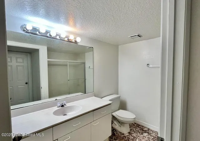 a bathroom with a glass shower door