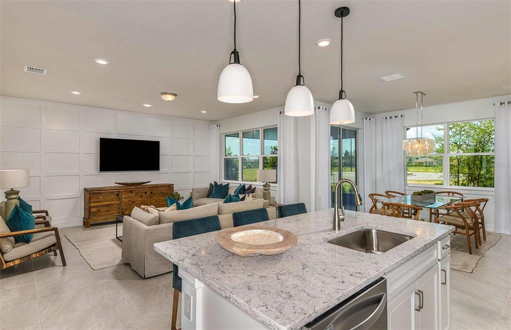 4029 Big Sky Drive Spring Hill, FL 34604 - Photo 6 of 14 a living room with furniture a flat screen tv and a large window
