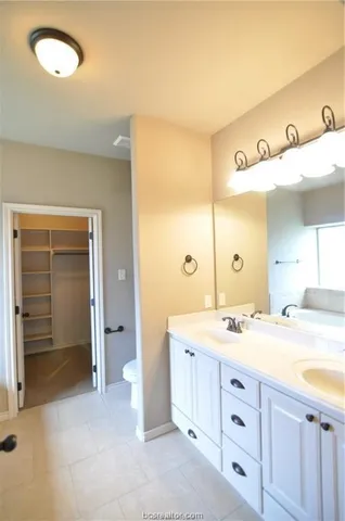 a spacious bathroom with a shower sink and mirror