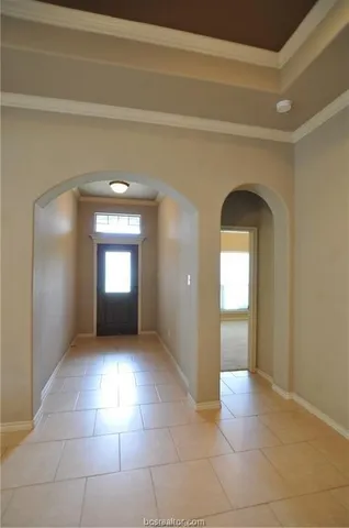 a view of a hallway with wooden floor and a living room