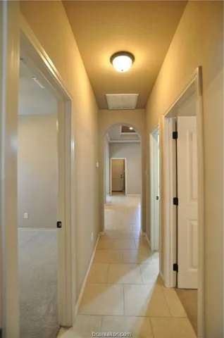 a view of a hallway with wooden shelves