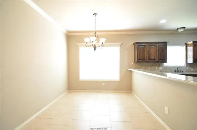 a view of a kitchen with a cabinet and a chandelier