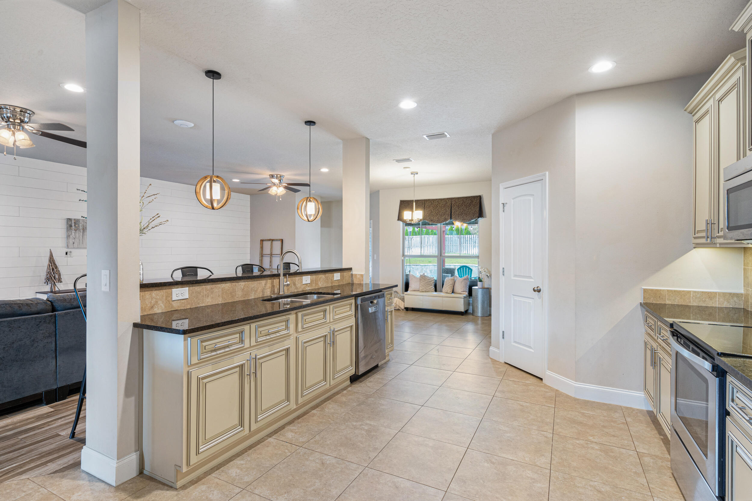 4646 Chanan Drive Crestview, FL 32539 - Photo 12 of 56 a large kitchen with granite countertop a sink and a stove