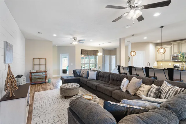 a living room with furniture and a chandelier