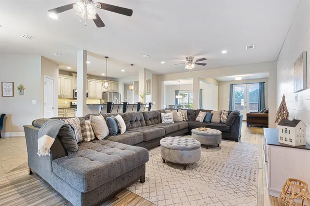 a spacious bedroom with a bed and a chandelier
