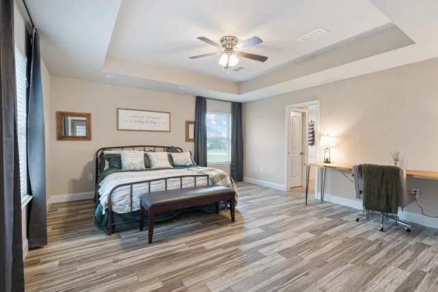 a spacious bedroom with a bed and a window