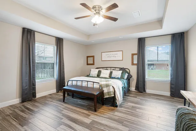 a bedroom with a bed a table and chair