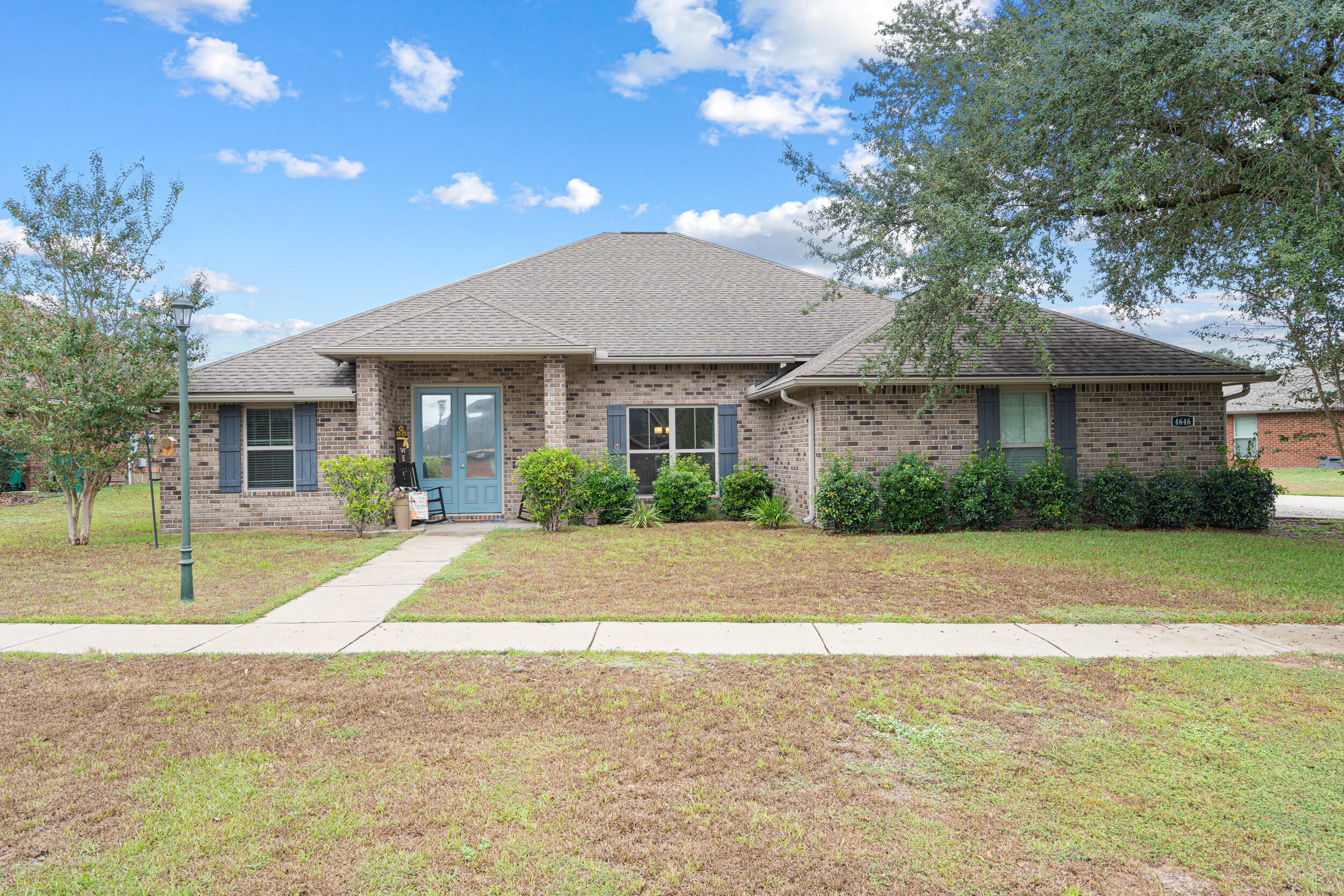4646 Chanan Drive Crestview, FL 32539 - Photo 2 of 56 a front view of a house with a garden