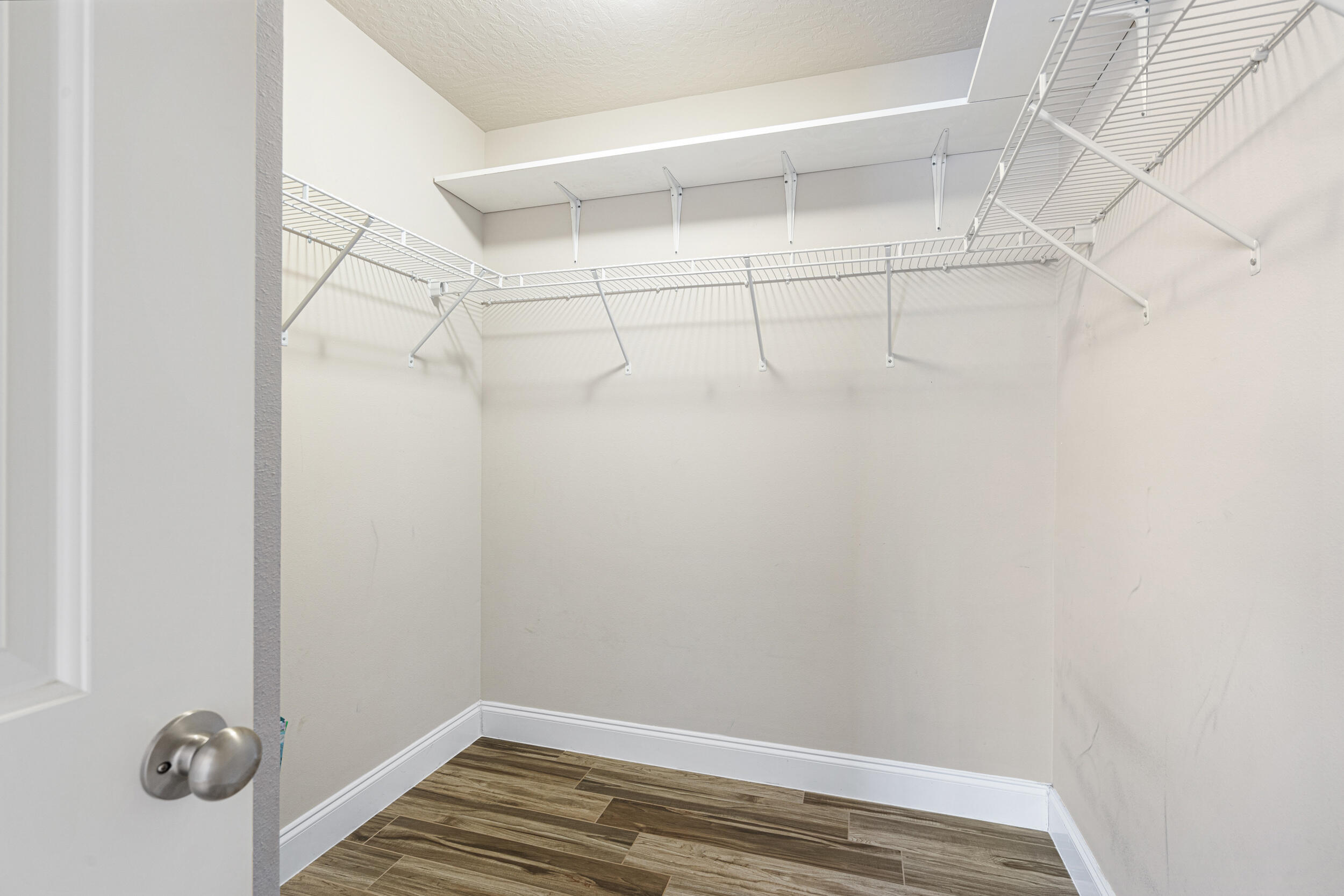 4646 Chanan Drive Crestview, FL 32539 - Photo 22 of 56 a view of a room with racks on the wall