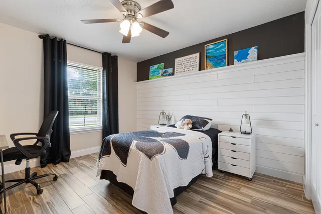 a bedroom with a bed and a flat screen tv