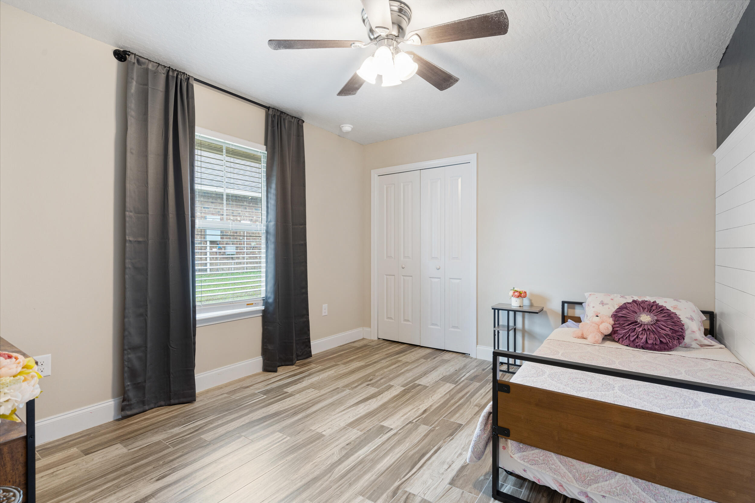 4646 Chanan Drive Crestview, FL 32539 - Photo 25 of 56 a bedroom with a bed and a chandelier