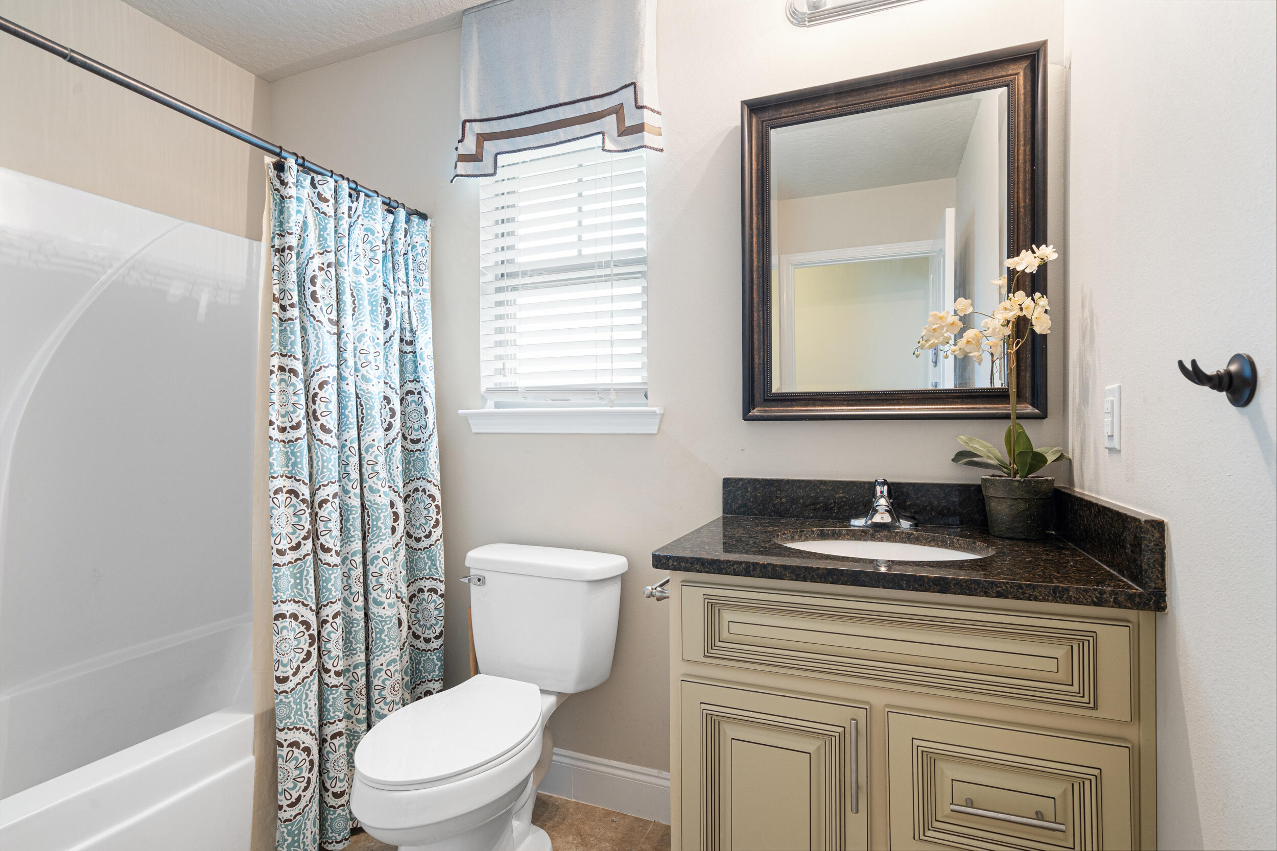 4646 Chanan Drive Crestview, FL 32539 - Photo 27 of 56 a bathroom with a granite countertop sink toilet a mirror a vanity and shower