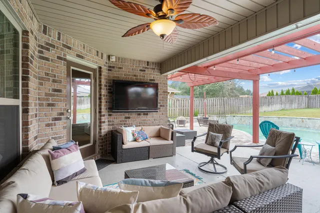 a view of a swimming pool with a patio and a yard