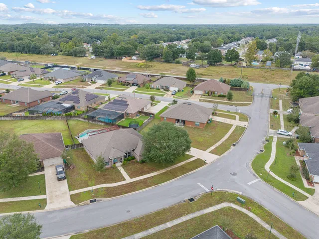 an aerial view of residential houses with outdoor space
