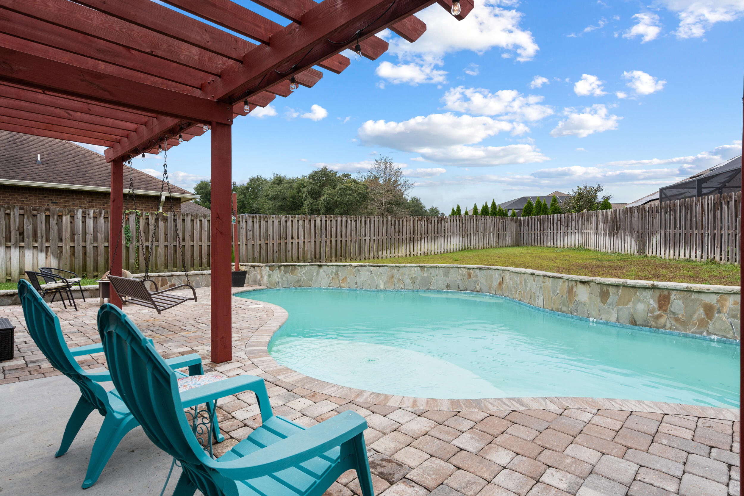 4646 Chanan Drive Crestview, FL 32539 - Photo 43 of 56 a view of swimming pool outdoor seating and city view
