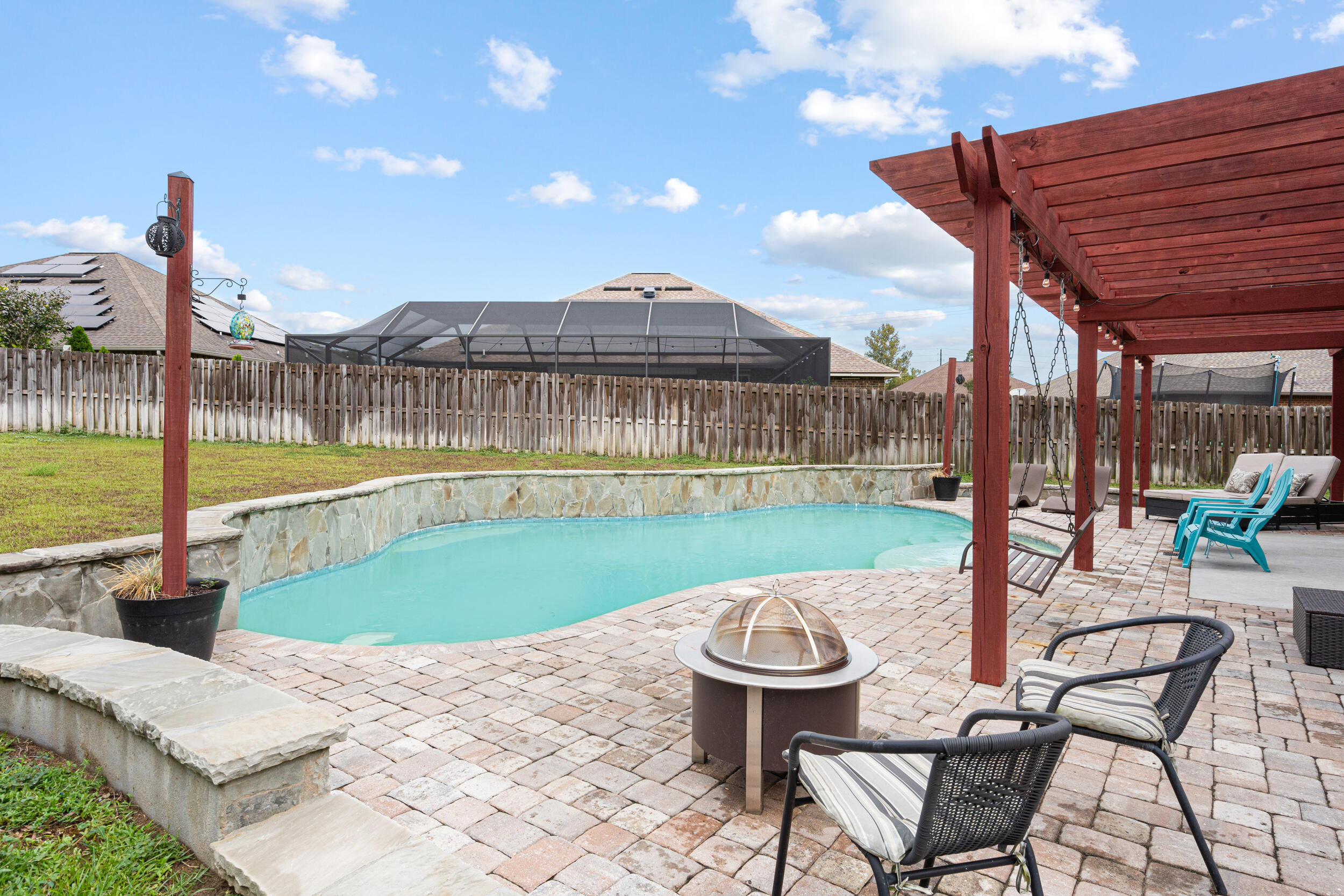 4646 Chanan Drive Crestview, FL 32539 - Photo 44 of 56 a view of a swimming pool with a patio and a yard