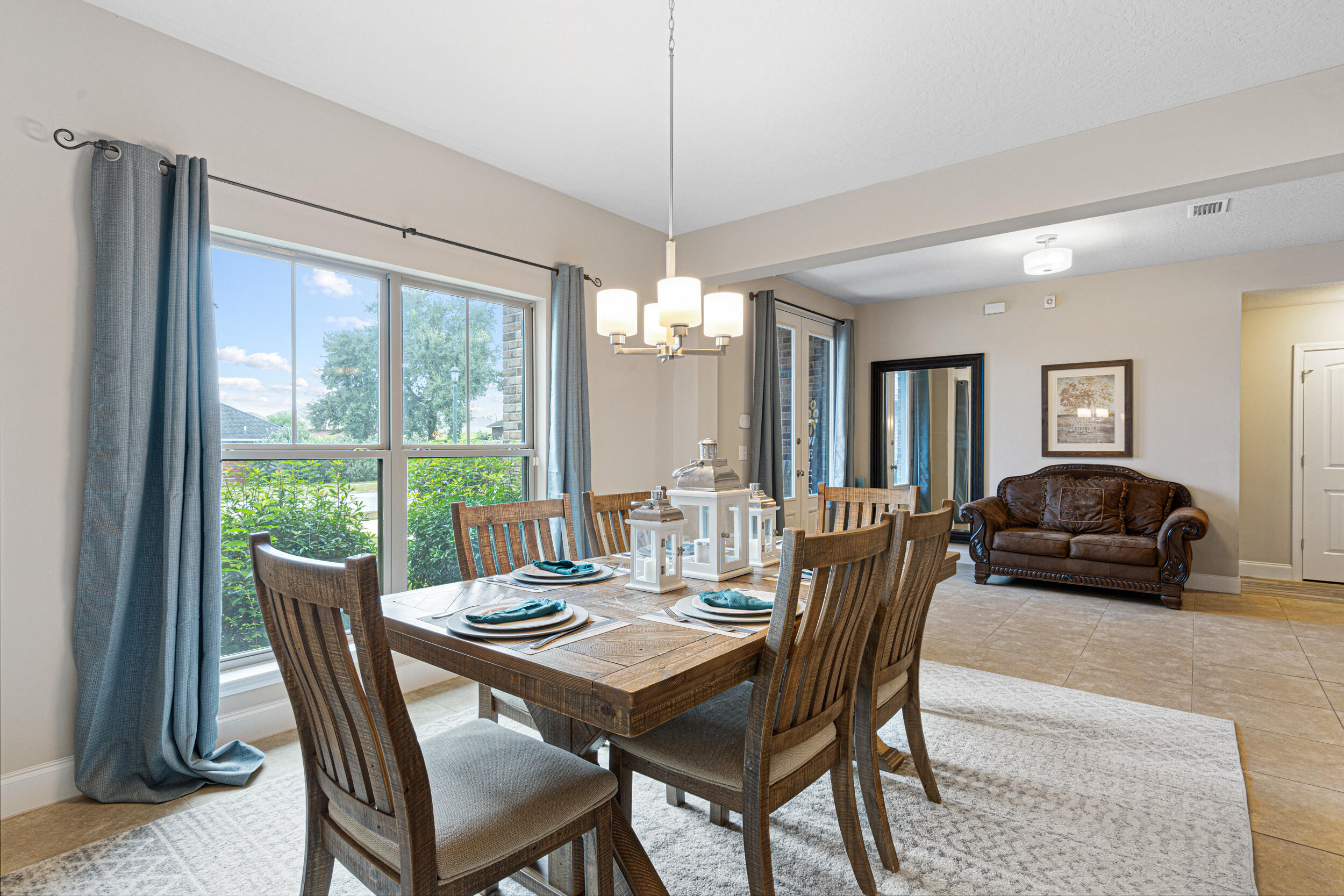 4646 Chanan Drive Crestview, FL 32539 - Photo 6 of 56 a dining room with furniture a chandelier and wooden floor
