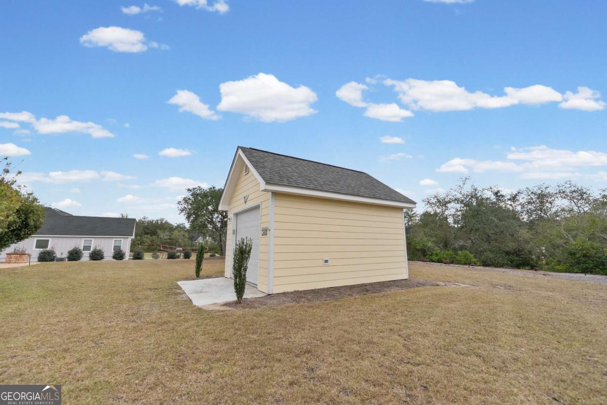 105 Plantation Pnes Drive Blackshear, GA 31516 - Photo 11 of 48 a view of a house with a yard and garage