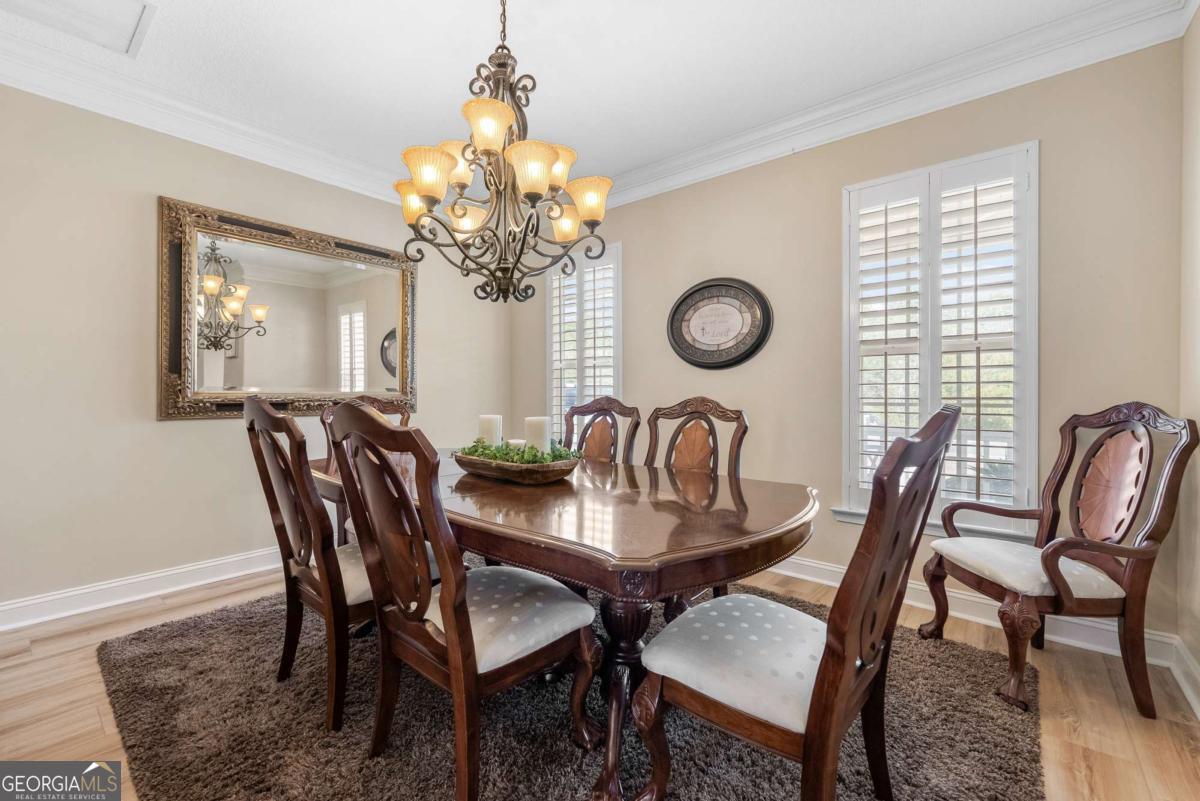 105 Plantation Pnes Drive Blackshear, GA 31516 - Photo 18 of 48 a dining room with furniture a chandelier and wooden floor