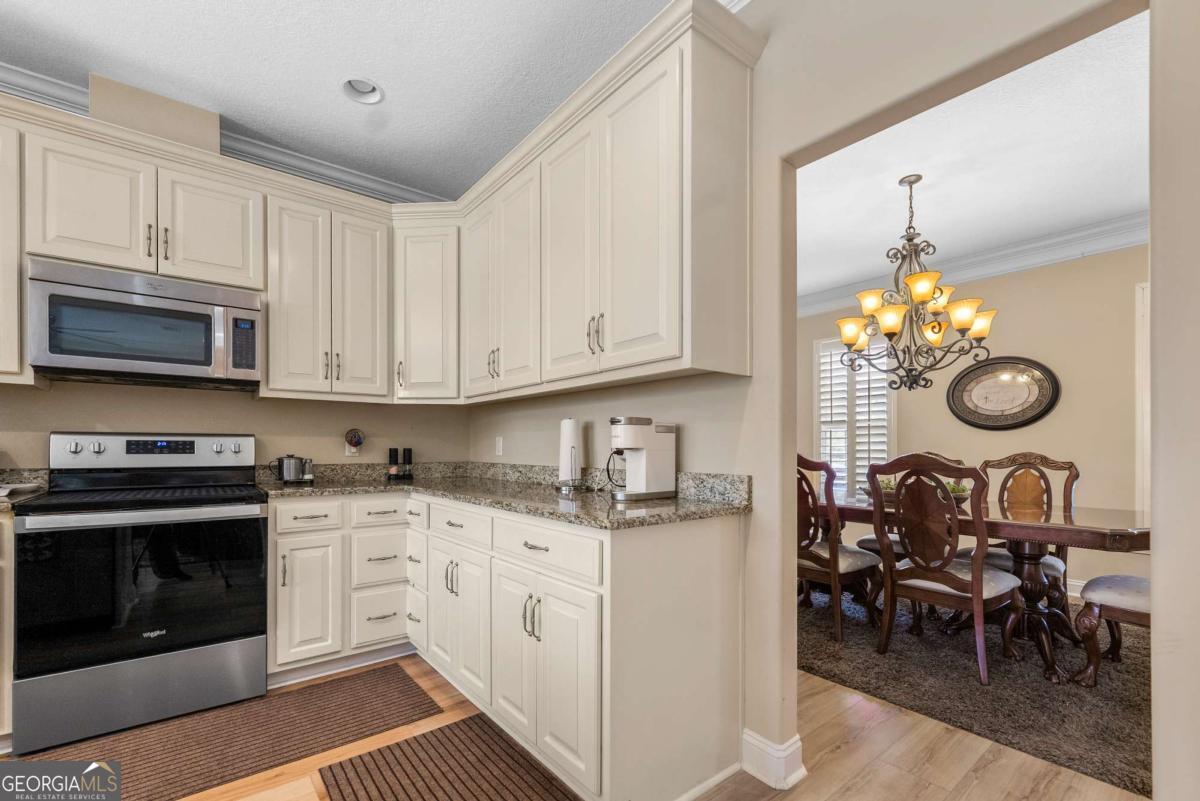 105 Plantation Pnes Drive Blackshear, GA 31516 - Photo 23 of 48 a kitchen with cabinets and stainless steel appliances