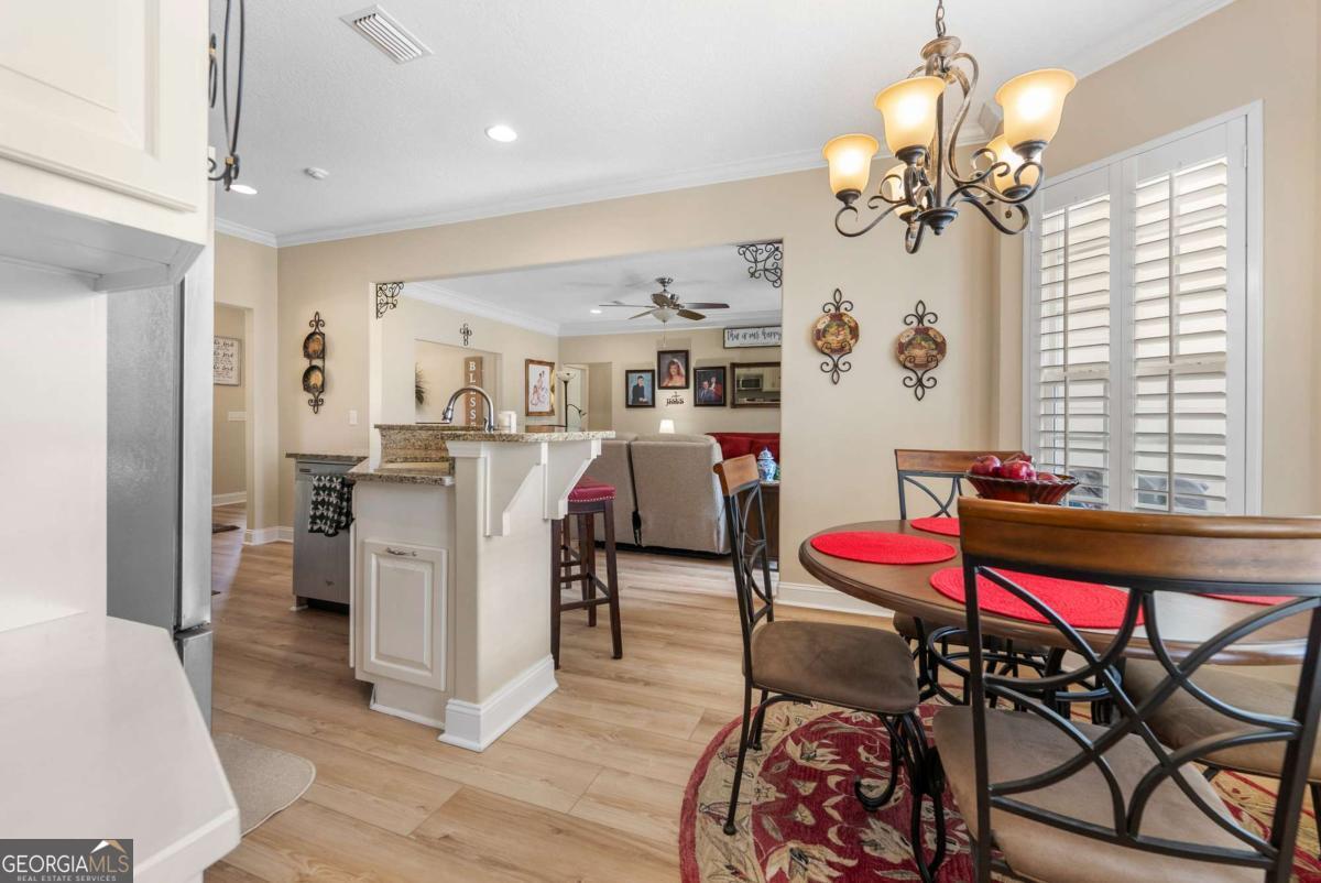 105 Plantation Pnes Drive Blackshear, GA 31516 - Photo 29 of 48 a living room with furniture and a chandelier