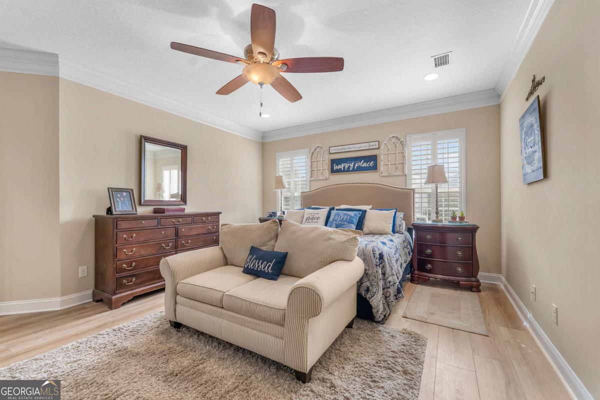 105 Plantation Pnes Drive Blackshear, GA 31516 - Photo 36 of 48 a bedroom with a large bed and ceiling fan