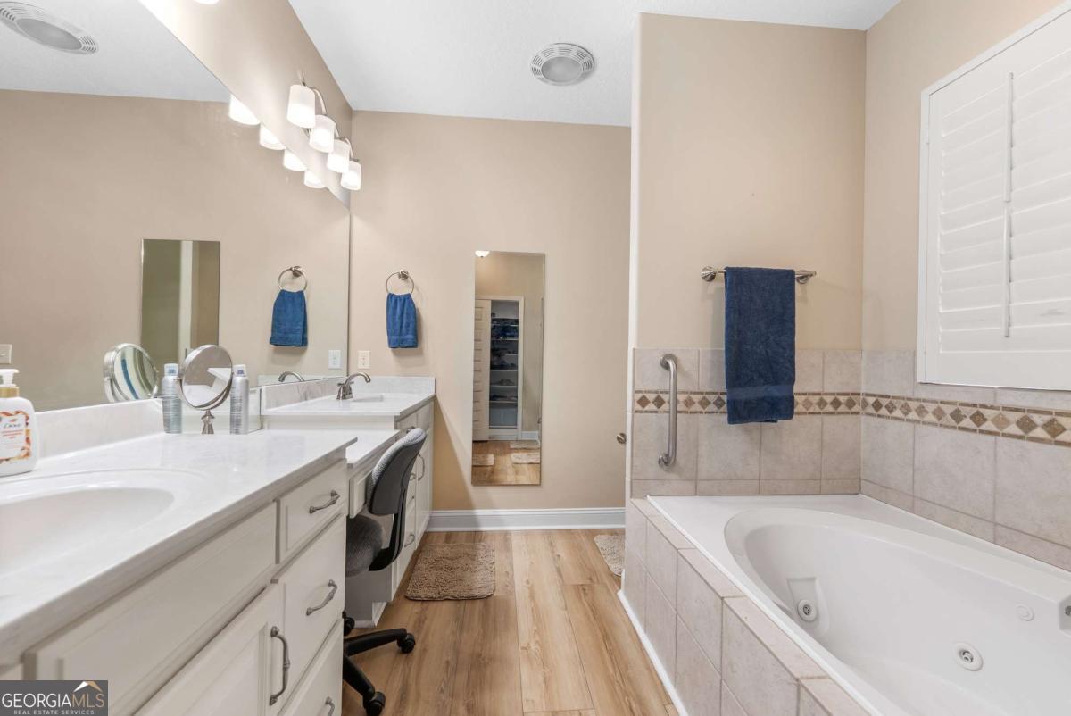 105 Plantation Pnes Drive Blackshear, GA 31516 - Photo 37 of 48 a spacious bathroom with a tub double sink and mirror