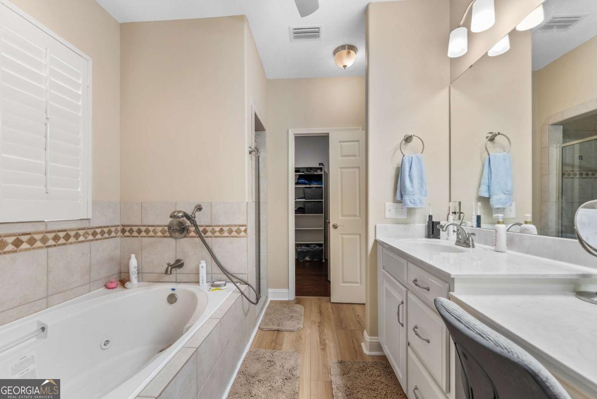 105 Plantation Pnes Drive Blackshear, GA 31516 - Photo 38 of 48 a bathroom with a tub sink and mirror