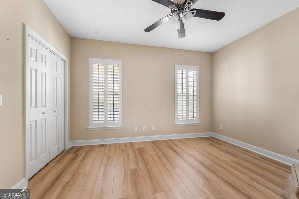 105 Plantation Pnes Drive Blackshear, GA 31516 - Photo 45 of 48 a view of an empty room with a window and wooden floor
