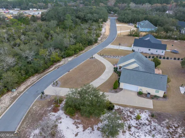 an aerial view of a house with a yard