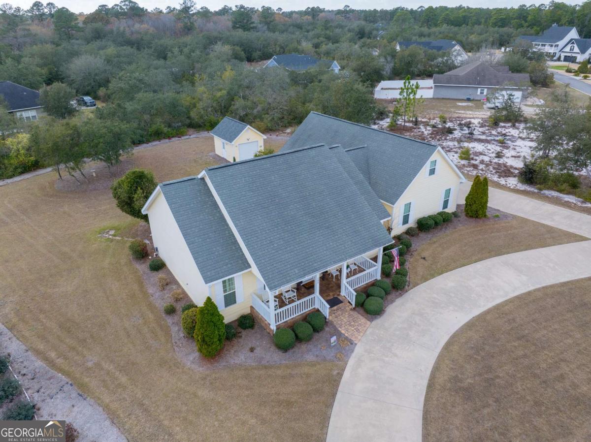 105 Plantation Pnes Drive Blackshear, GA 31516 - Photo 8 of 48 an aerial view of a house with a yard and lake