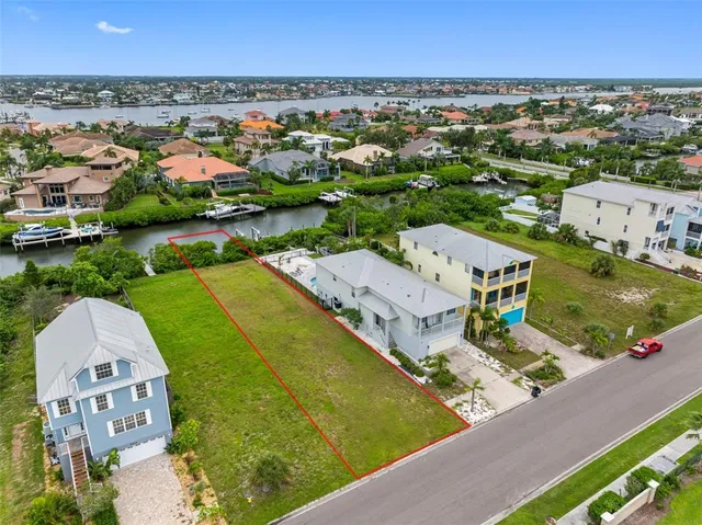 an aerial view of residential houses with outdoor space and seating