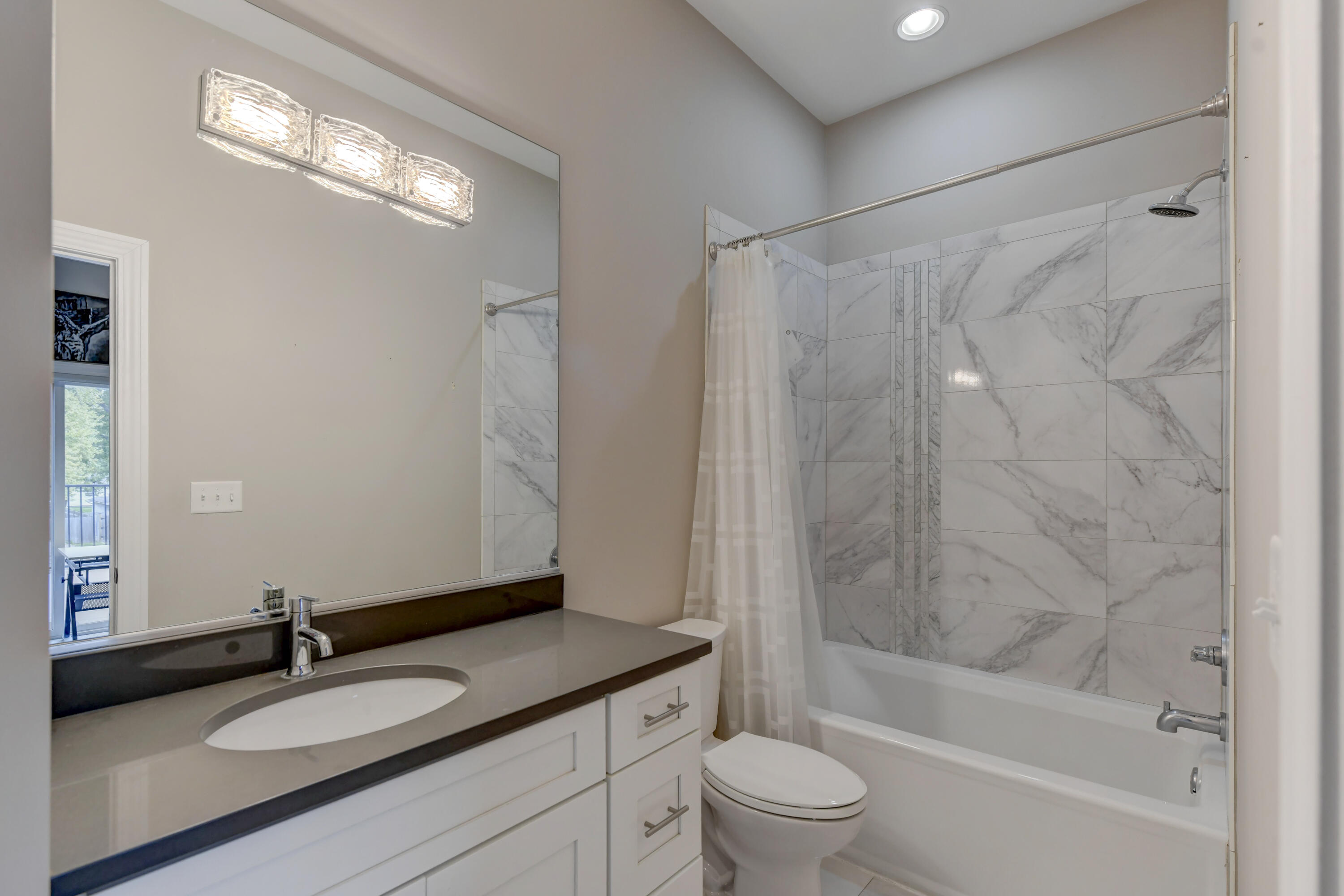 360 North Indiana Avenue Crown Point, IN 46307 - Photo 13 of 22 a bathroom with a granite countertop sink a toilet and shower