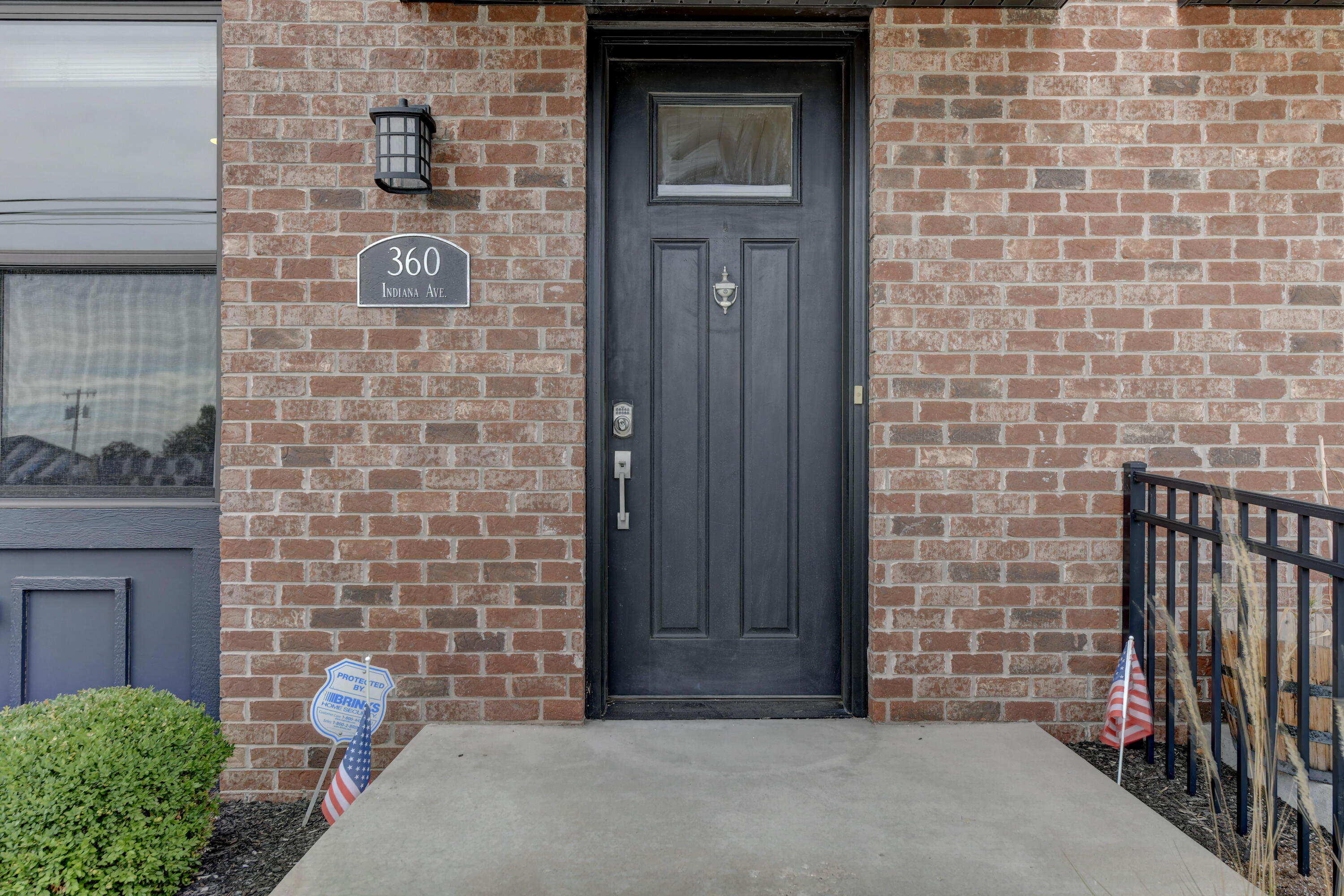360 North Indiana Avenue Crown Point, IN 46307 - Photo 2 of 22 a brick building with a bench in front of door