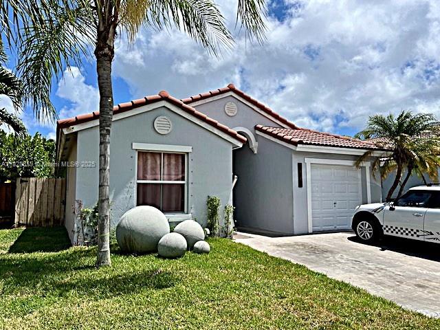 1988 Southeast 12th Street Homestead, FL 33035 - Photo 1 of 44 a front view of a house with garden