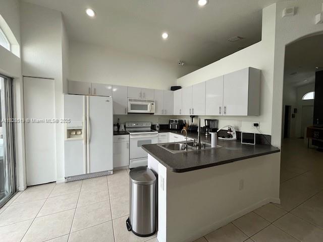 1988 Southeast 12th Street Homestead, FL 33035 - Photo 26 of 44 a kitchen with kitchen island a sink stove and refrigerator