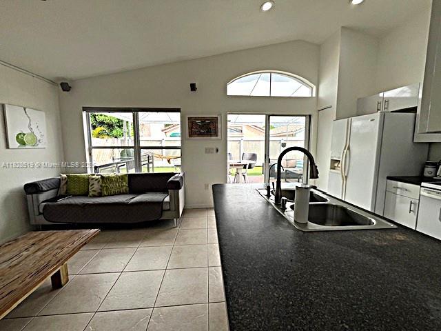 1988 Southeast 12th Street Homestead, FL 33035 - Photo 30 of 44 a living room with furniture a window and a flat screen tv