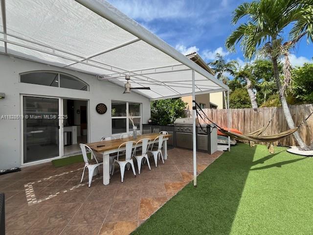 1988 Southeast 12th Street Homestead, FL 33035 - Photo 32 of 44 a view of a patio with table and chairs and potted plants