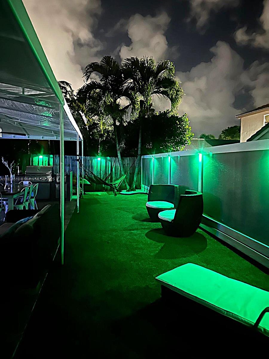 1988 Southeast 12th Street Homestead, FL 33035 - Photo 35 of 44 a view of a chair and table in the garden