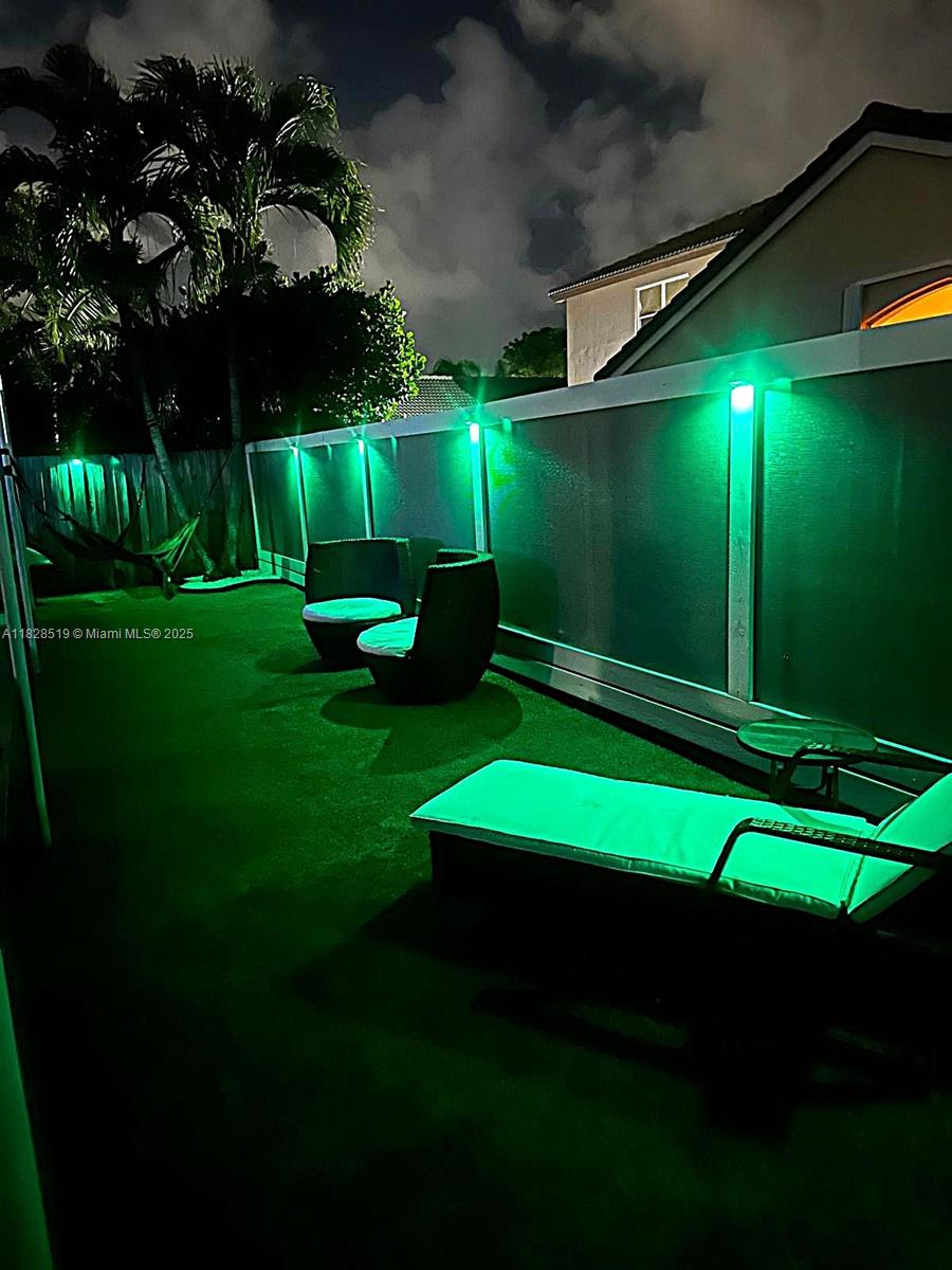 1988 Southeast 12th Street Homestead, FL 33035 - Photo 36 of 44 a view of an chairs and table in the garden