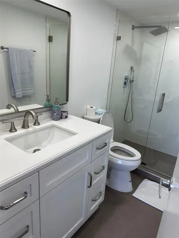 a bathroom with a toilet sink and shower